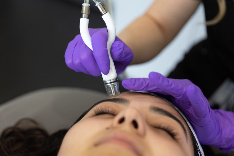 Closeup of a young woman with dark hair getting a DiamondGlow Facial in Lake Placid FL
